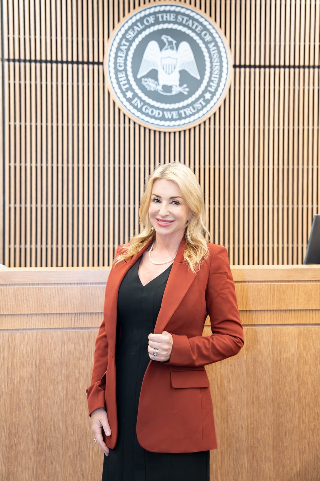 Keri H. Carroll in the courtroom, before the Great Seal of the State of Mississippi